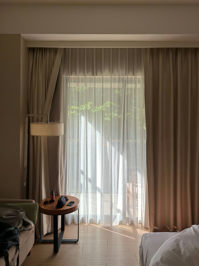 Sunlight through sheer curtains in a quiet bedroom