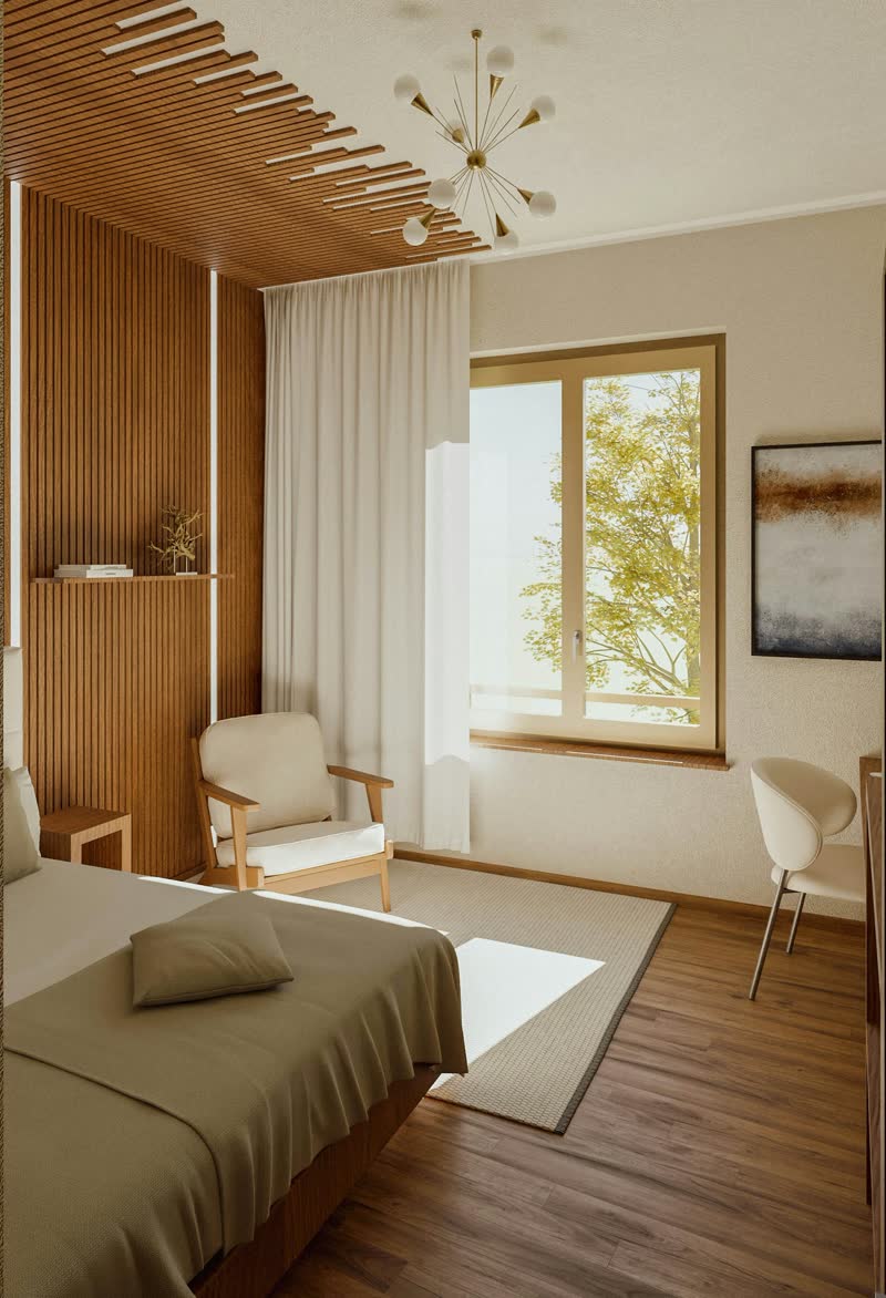A bright upstairs room with wooden panelling, light chairs and a window onto trees